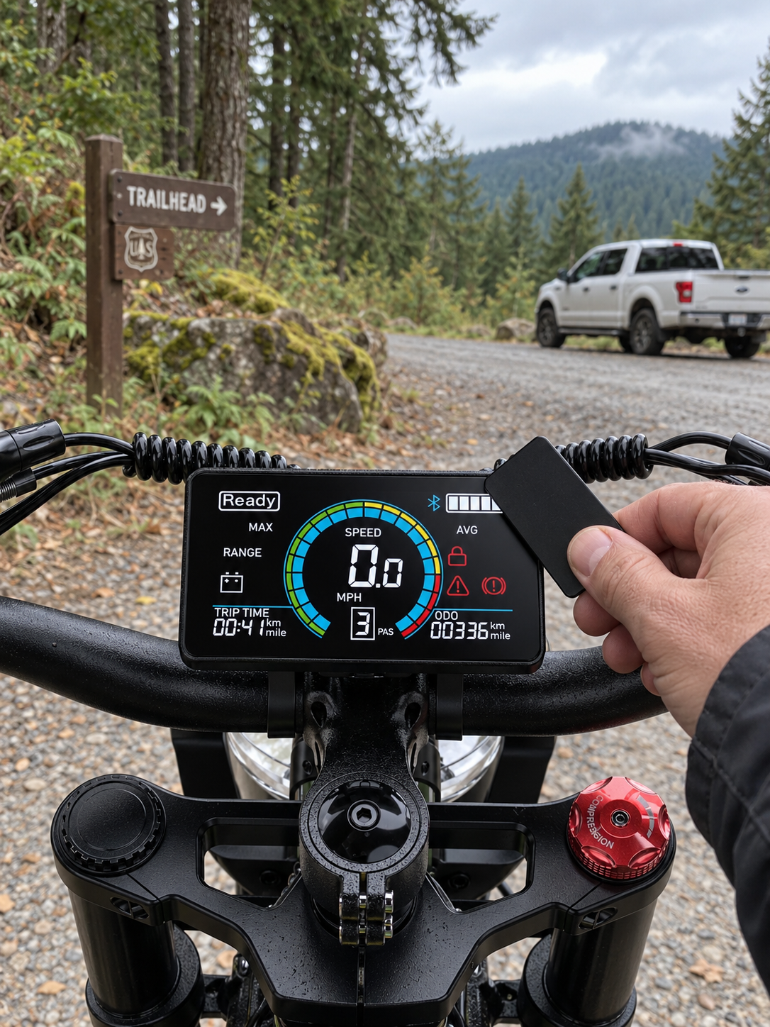 NFC card held beside the original horizontal Helokeep display at an American forest trailhead
